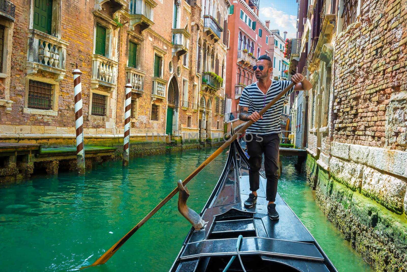 Gondolier on canal of venice by Givaga
