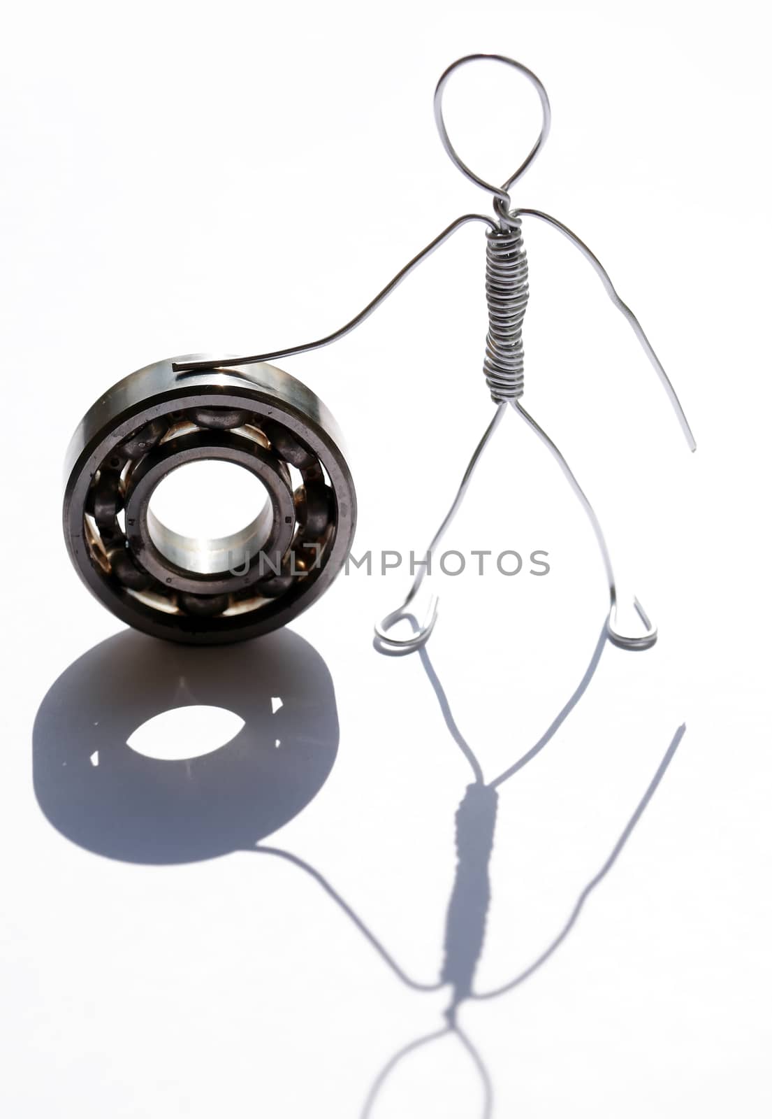 Man made from aluminum wire near ball bearing