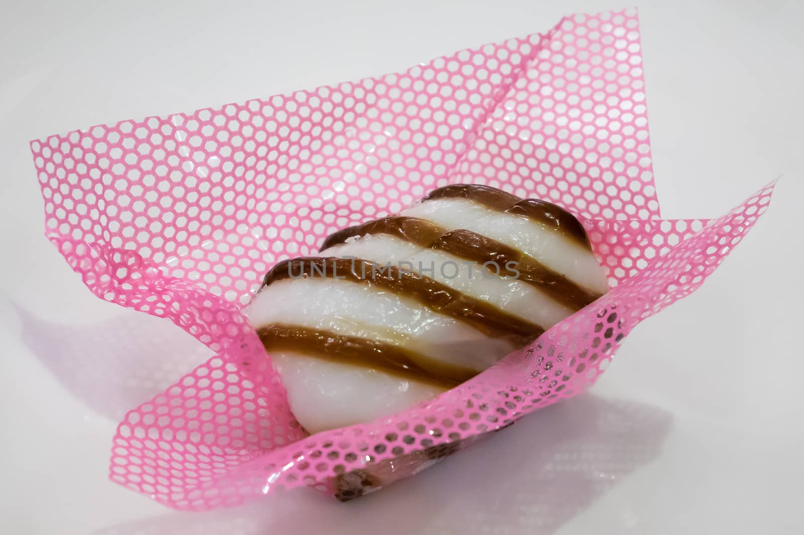 The close up of Taiwanese mochi candy dessert on the white table.