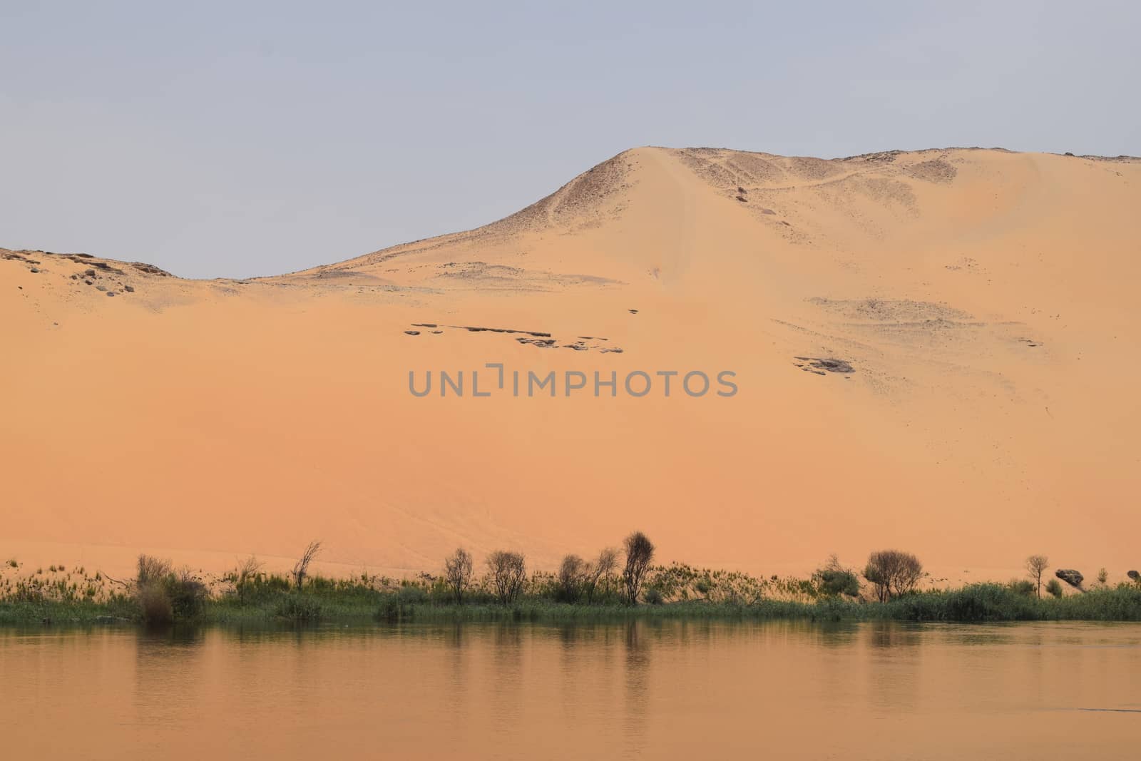 The beginning of the Sahara Desert With the Nile in the foreground taken in Aswan Egypt with Nile River Boat by TheDutchcowboy