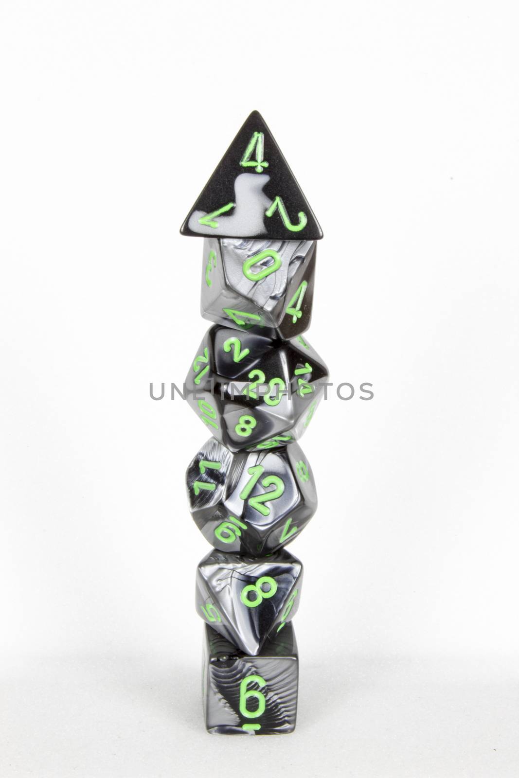 Isolated poly dice tower marble black with green numbers