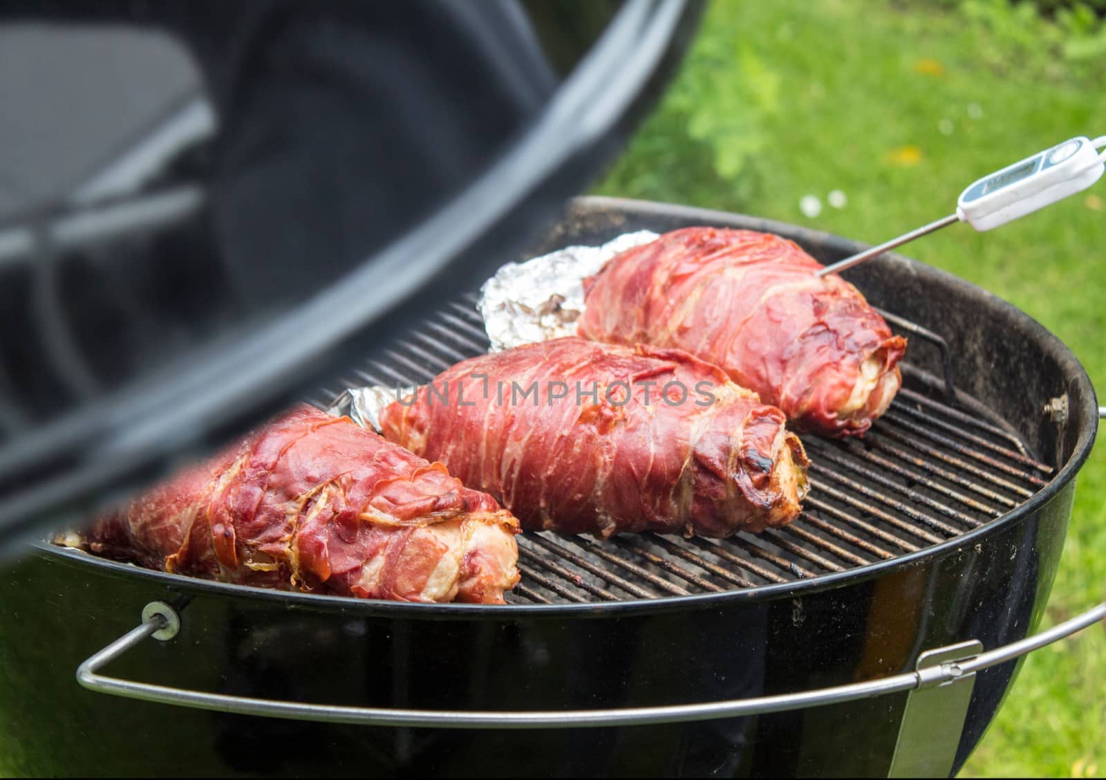 Meat wrapped in ham on the barbecue