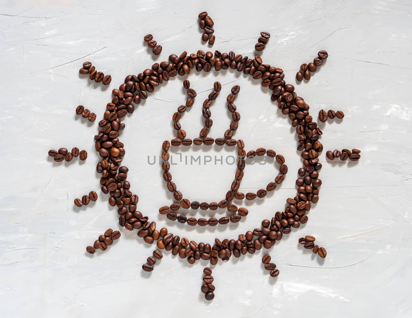 Coffee bean in cup and sun shape on white floor. Concept of coffee time in morning.