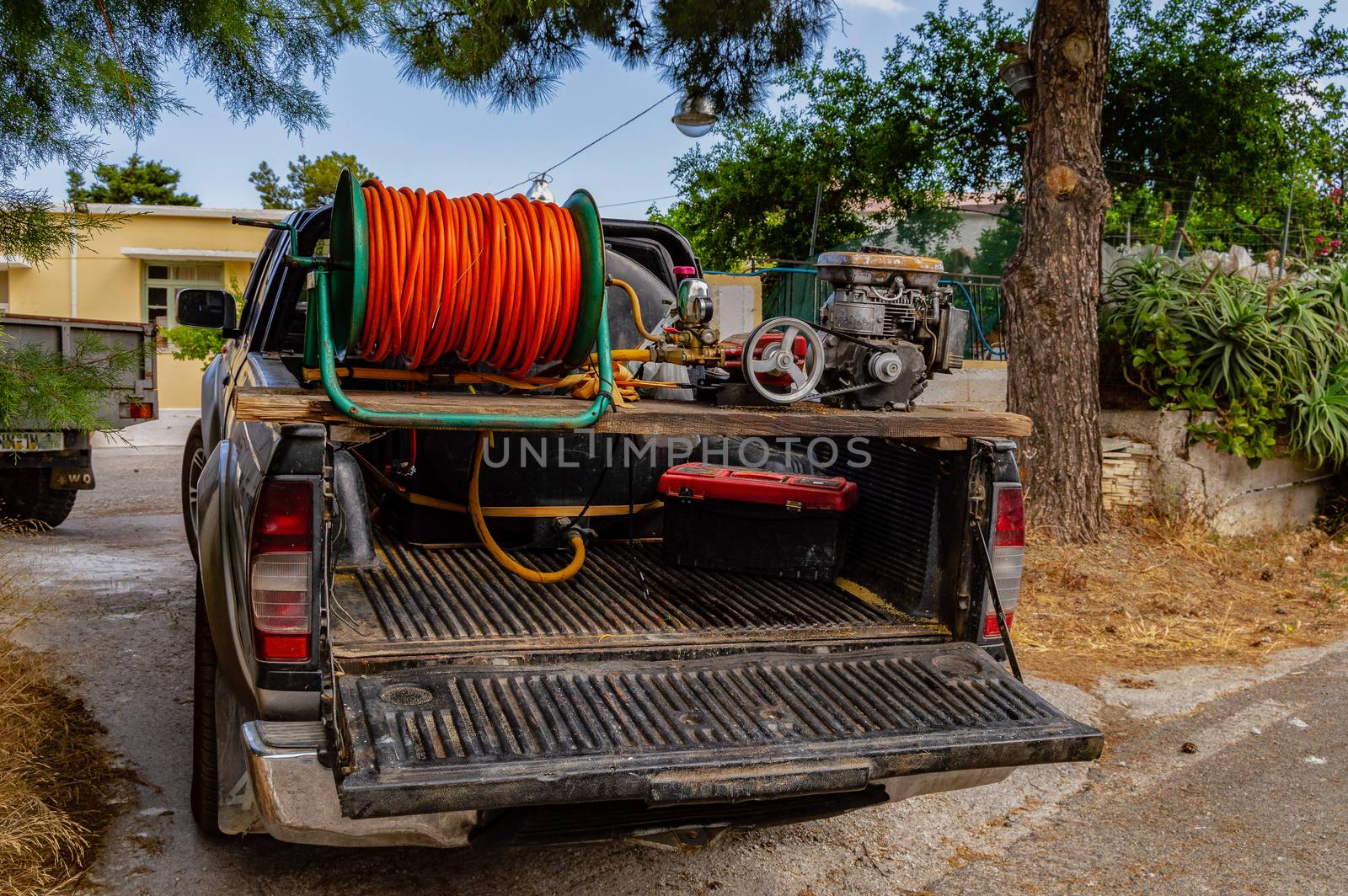 pickup arranged in an irrigation truck with a tank and a water pump on the island of Crete in Greece