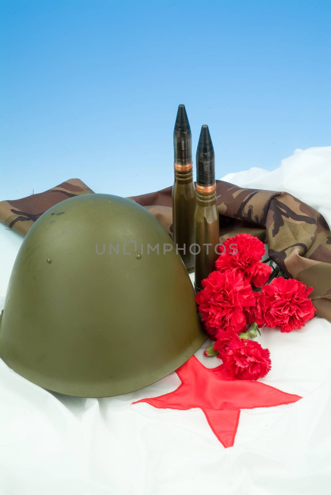 Flowers and army equipment on a studio background