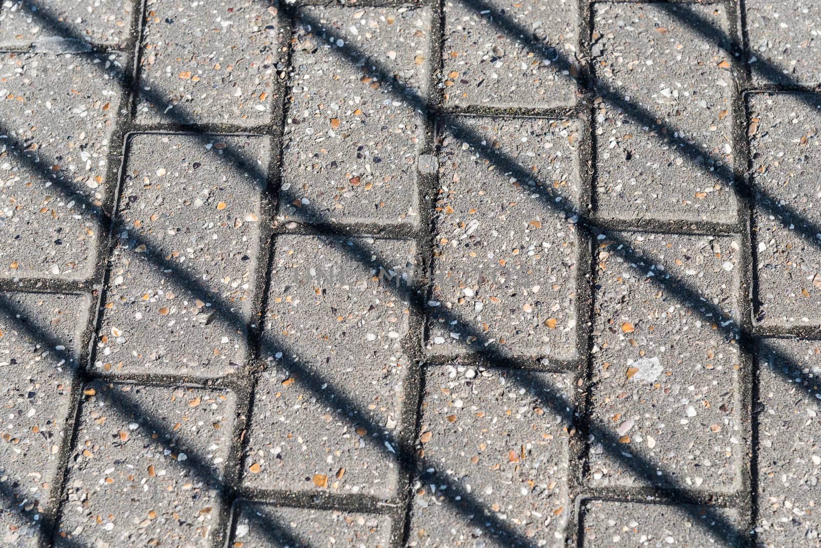 Diagonal shadows on the pavement by tomypety
