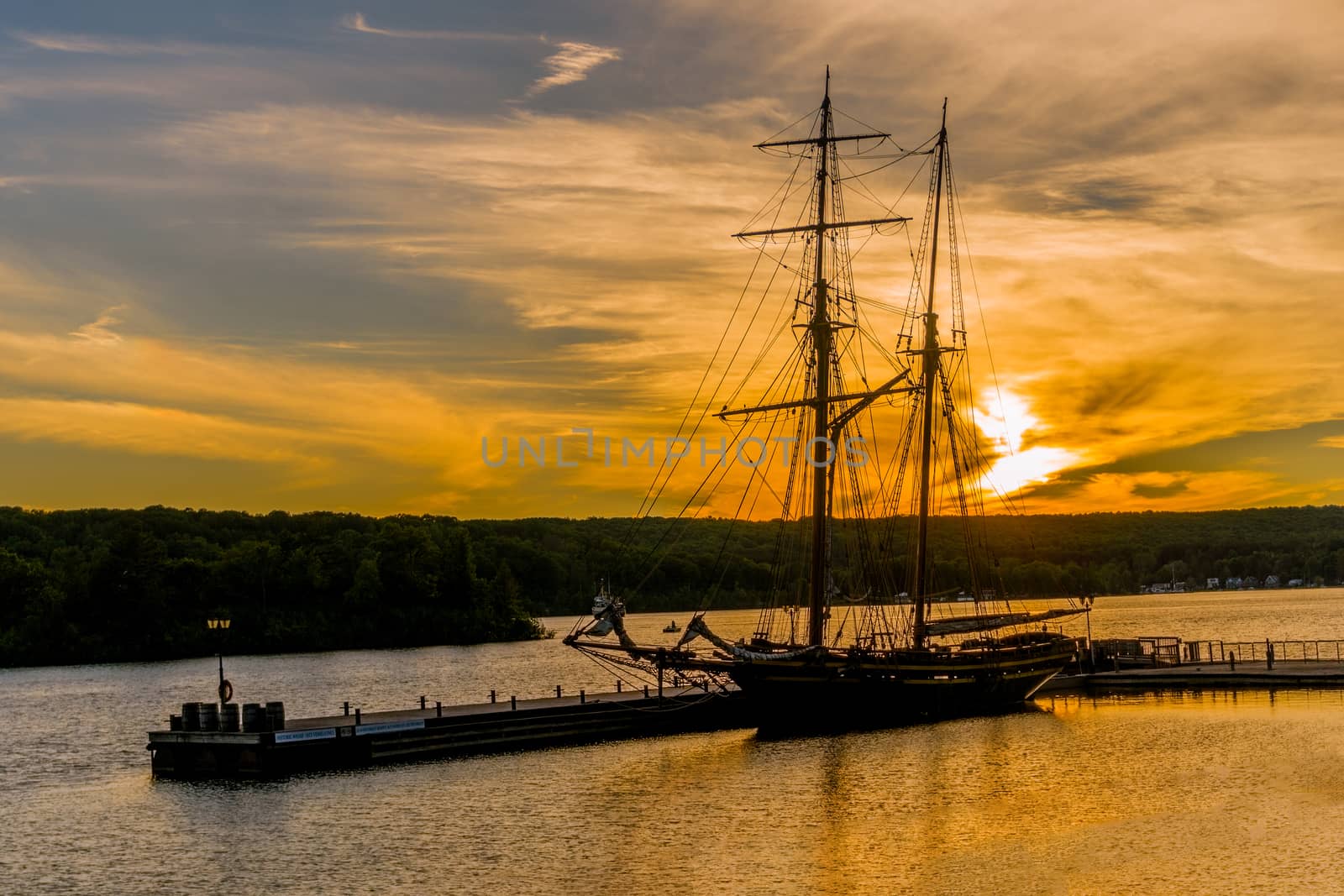 Two-masted brig moored at sunset at the pier by ben44