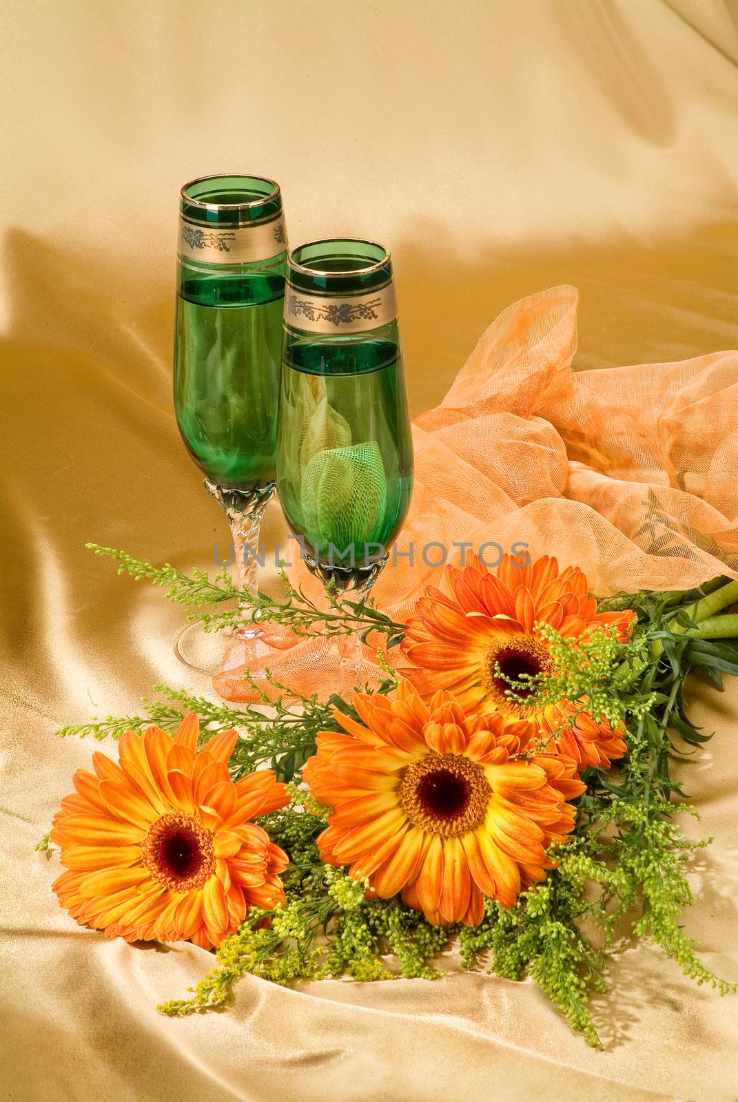 Glasses with wine on a decorative fabric background
