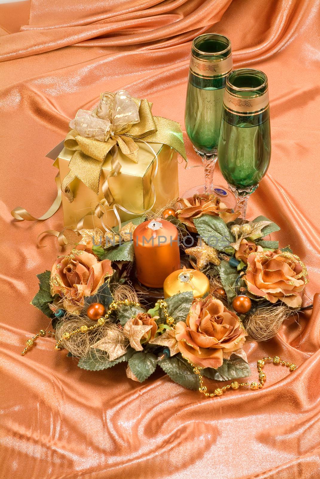 Glasses with wine on a decorative fabric background