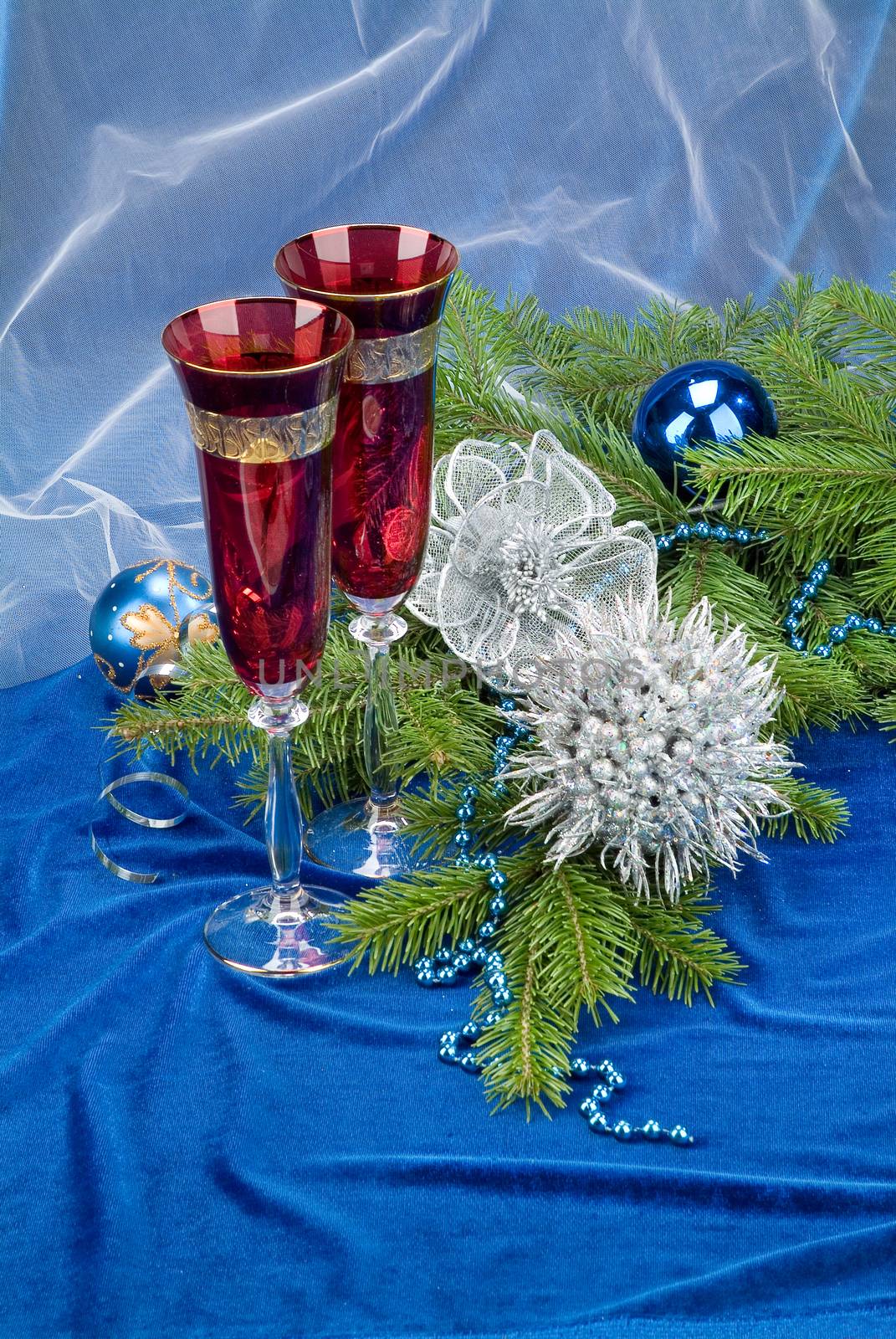 Glasses with wine on a decorative fabric background