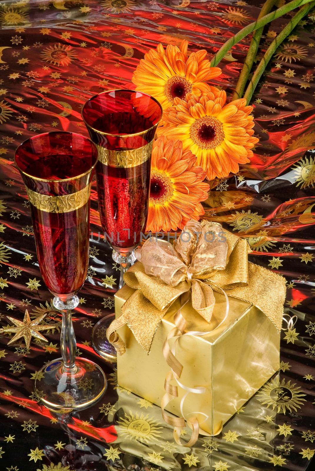 Glasses with wine on a decorative fabric background