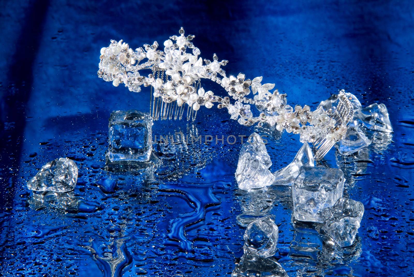 Jewelry and crystals of ice on a glass background