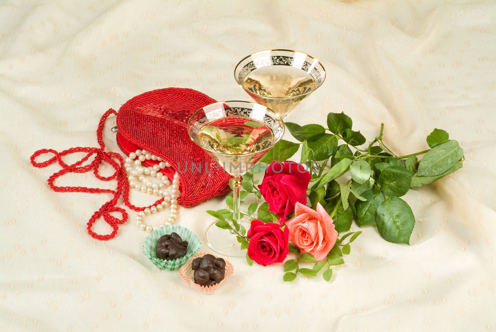 Glasses with wine on a decorative fabric background