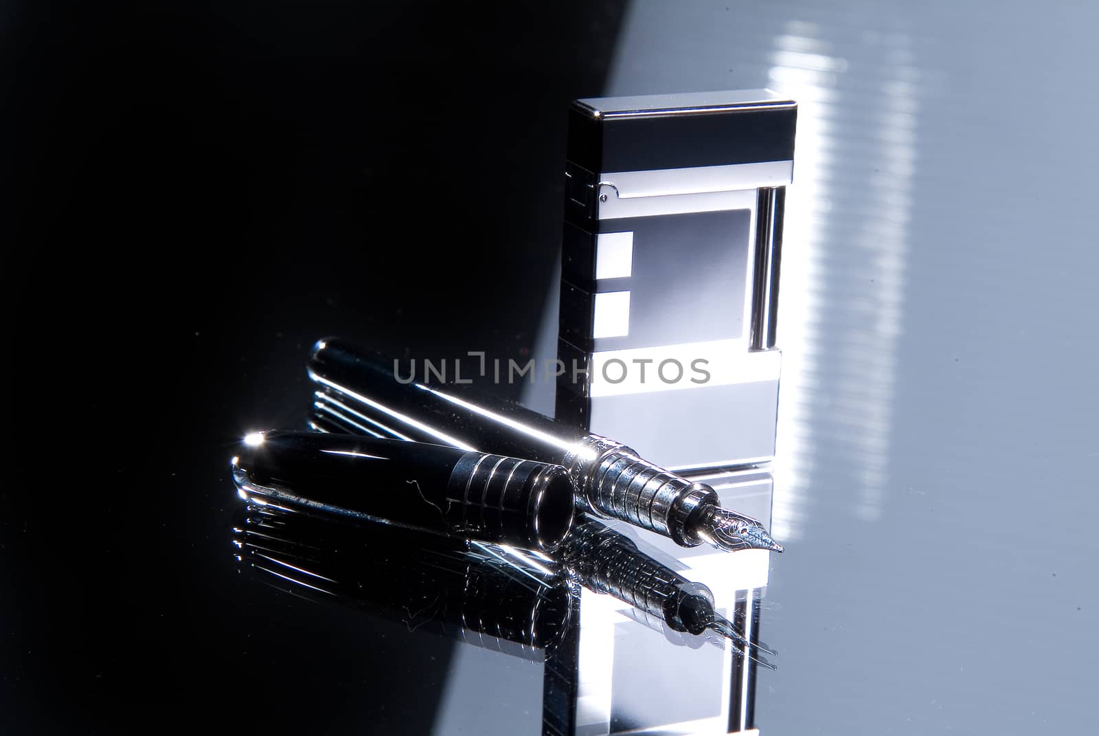 Lighter and pen on a glass background