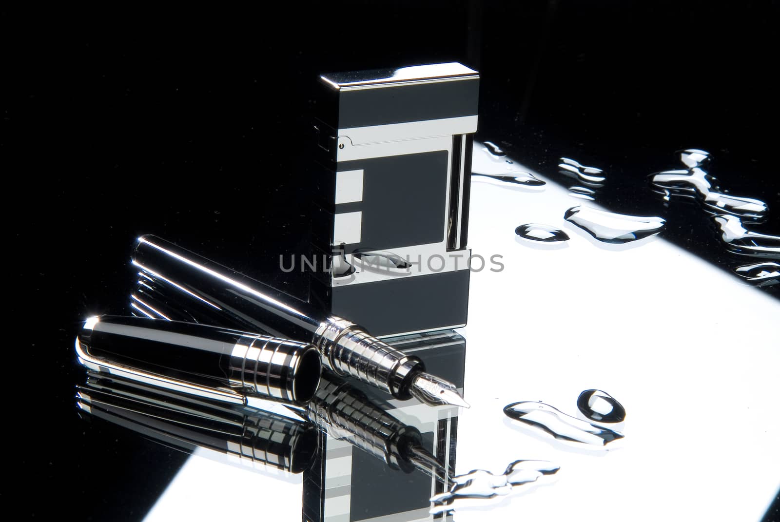 Lighter and pen on a glass background