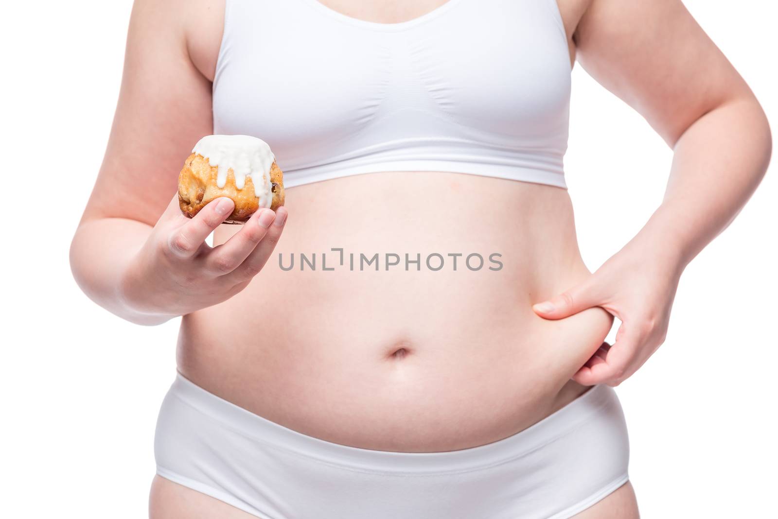 fat woman with calorie muffin in her hand squeezes belly closeup by kosmsos111