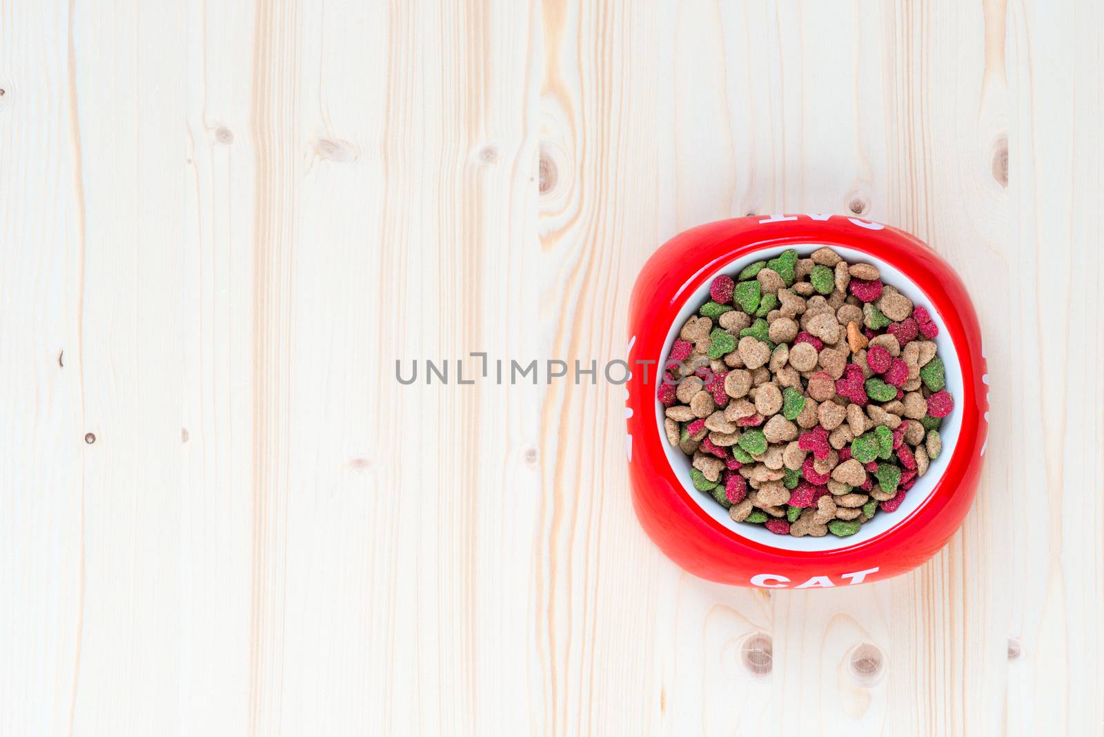 top view of a bowl of dry cat food, space left