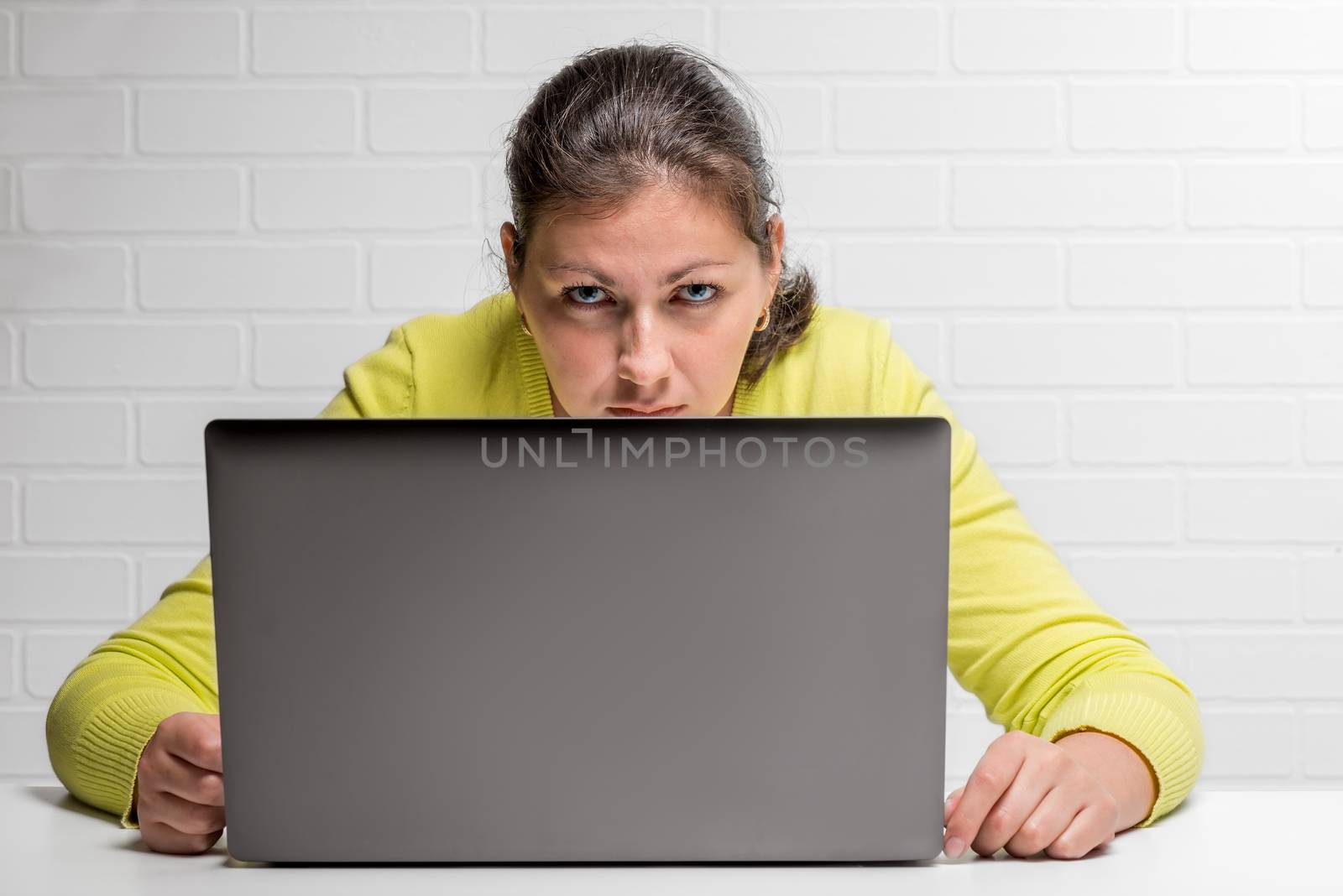 A woman hacker with a laptop steals data by kosmsos111