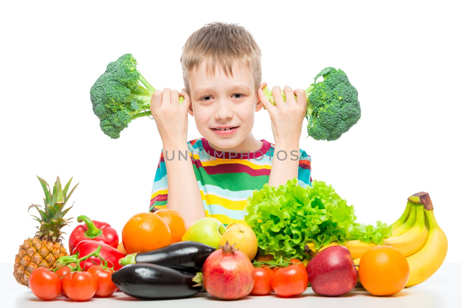 Boy 10 years old with broccoli and a bunch of vegetables and fru by kosmsos111