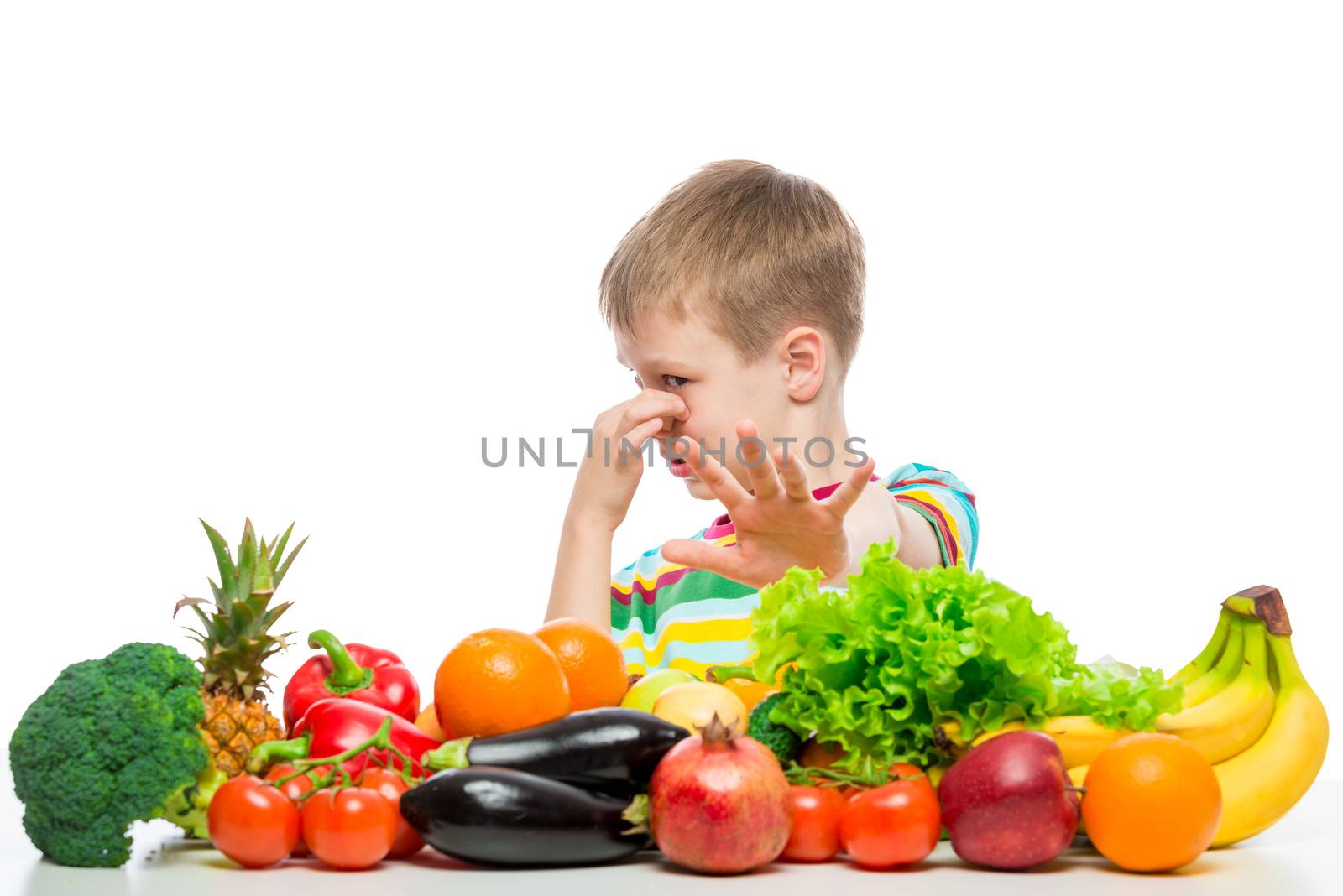 Boy and vegetables, unloved food concept photo by kosmsos111