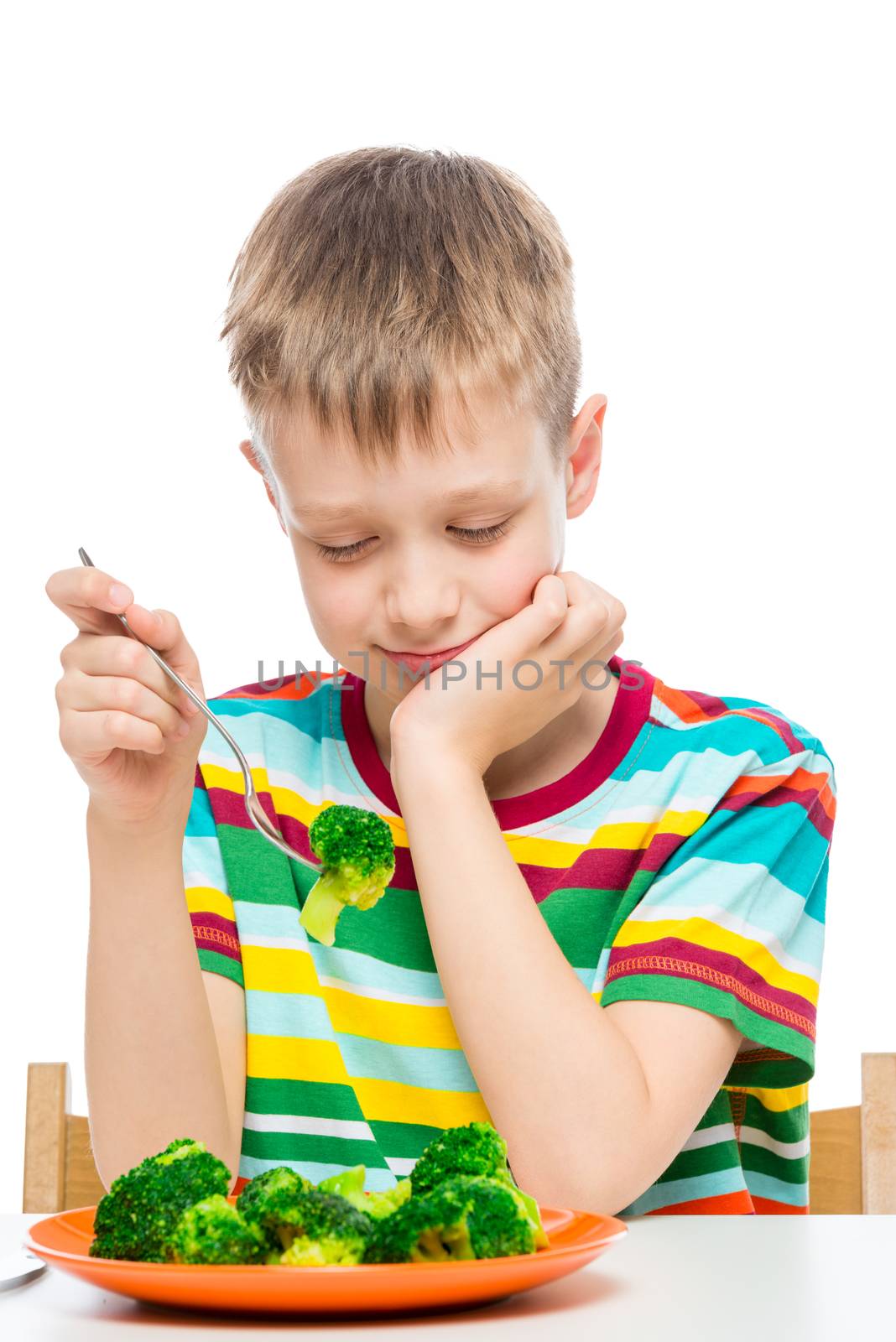 Portrait of a boy on a diet, on a fork wholesome broccoli