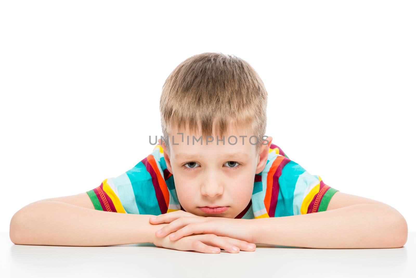 portrait of a sad boy of 10 years on white background isolated by kosmsos111