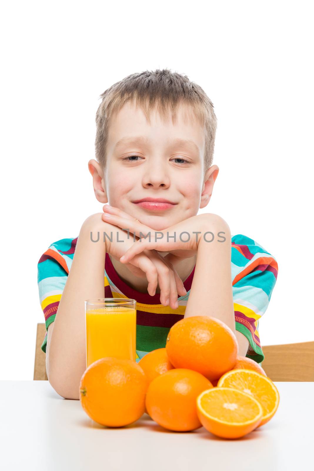 portrait of a boy with fresh orange juice on a white background in the studio