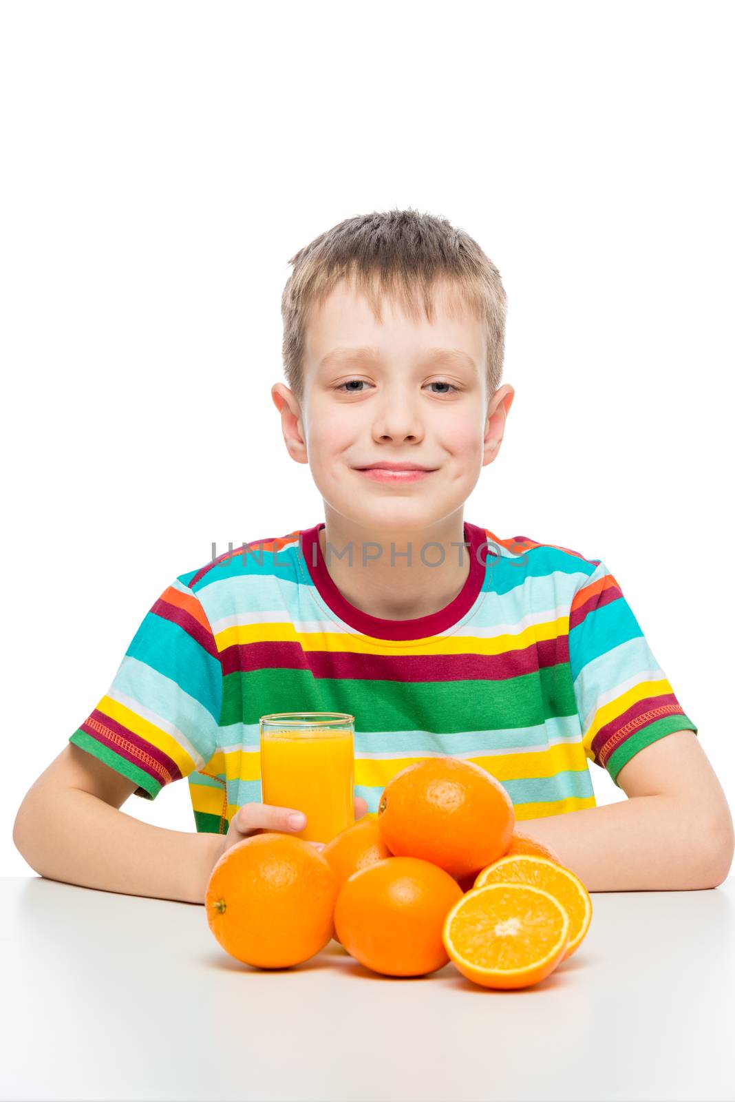 boy with oranges and a glass of fresh orange juice at the table by kosmsos111
