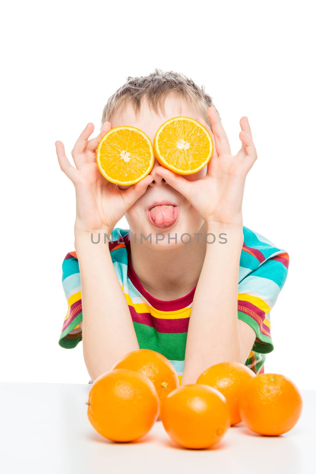 humorous photo of a boy with oranges halves on a white background in the studio
