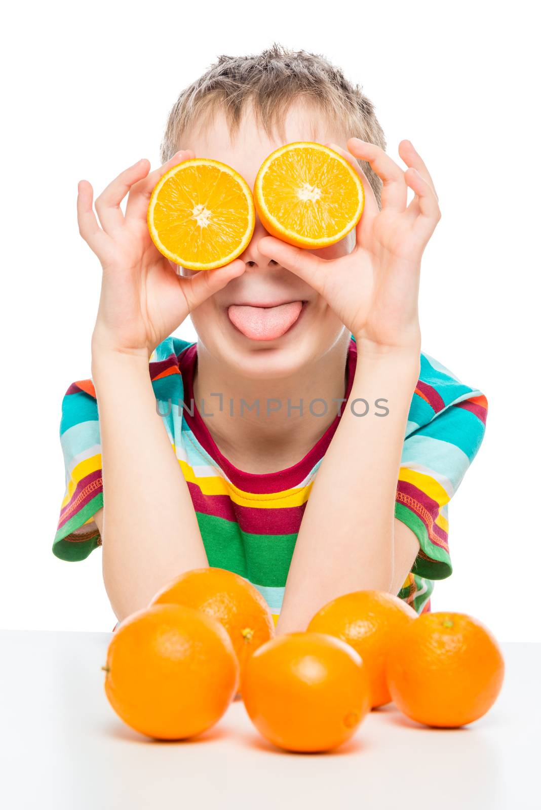 funny portrait of a boy with oranges on a white background