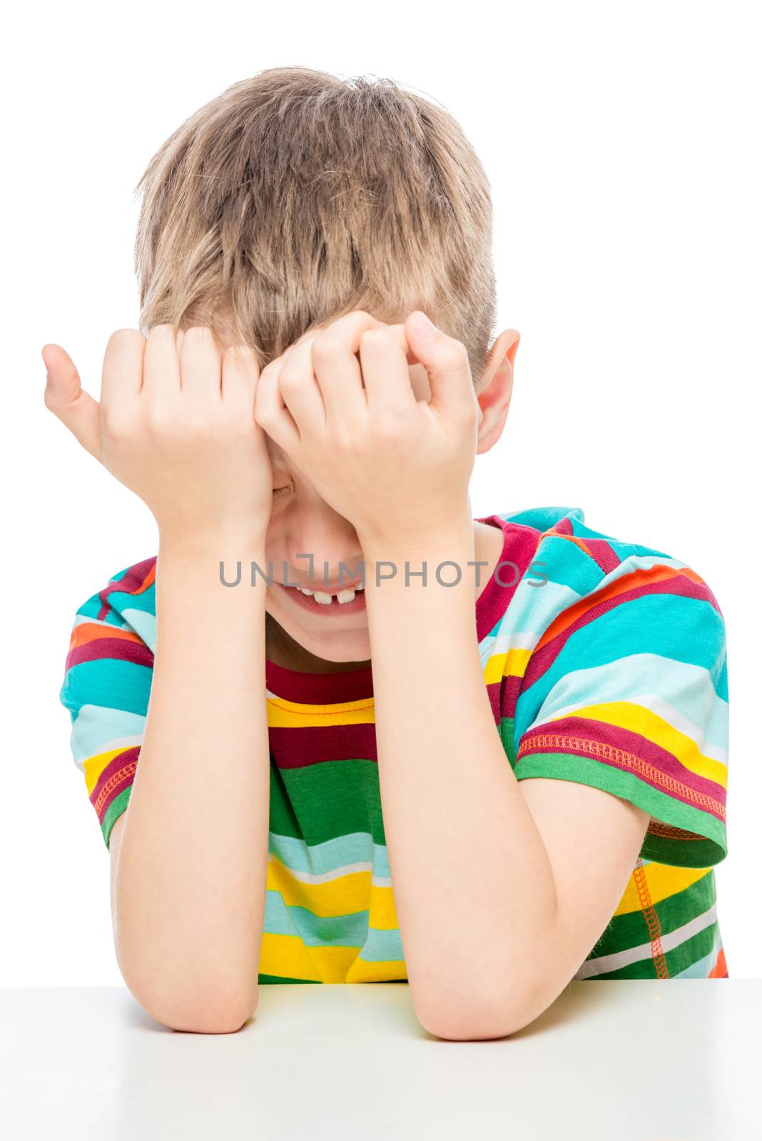 emotional portrait of a 10 years old boy at the table on a white by kosmsos111