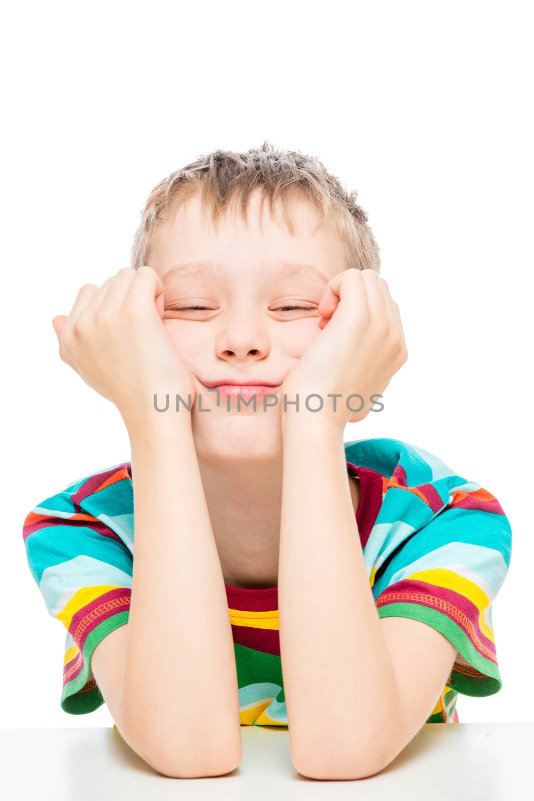 boy in a striped t-shirt at the table on a white background is insulated