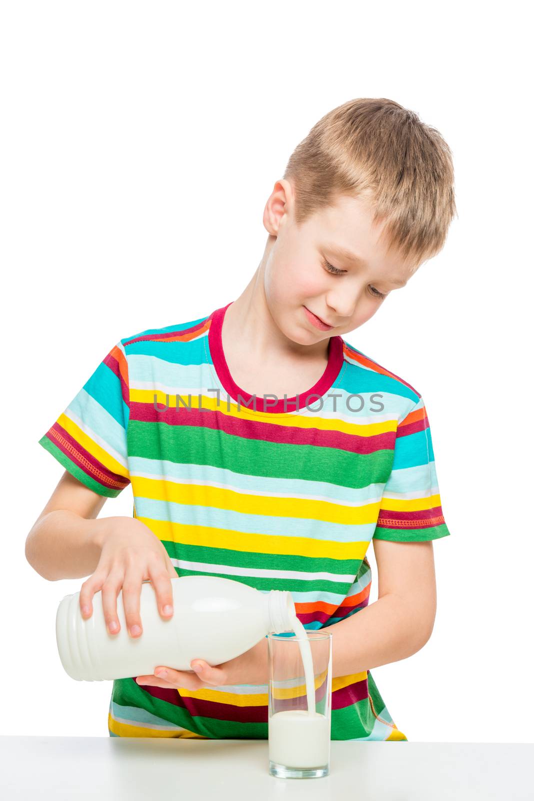 boy pours milk from a glass bottle, portrait is isolated
