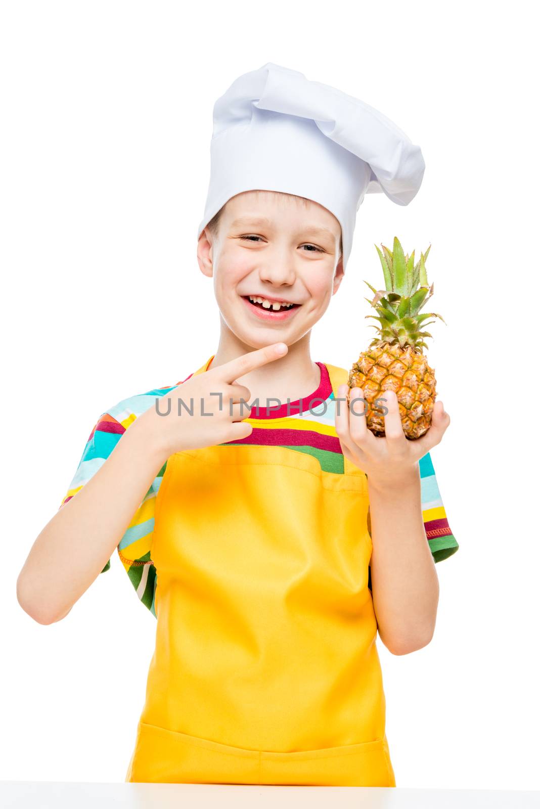 little cook in a cap with a mini pineapple on a white background in an apron