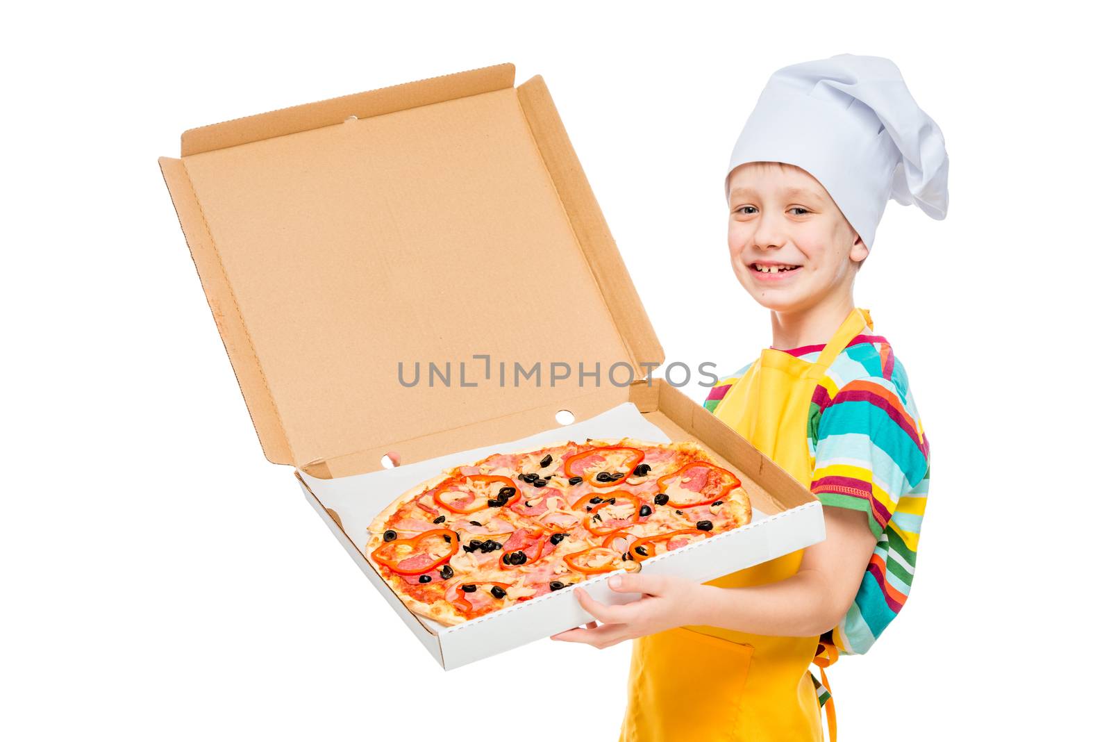 portrait of a child cook in a cap with a pizza in a box on a white background in the studio