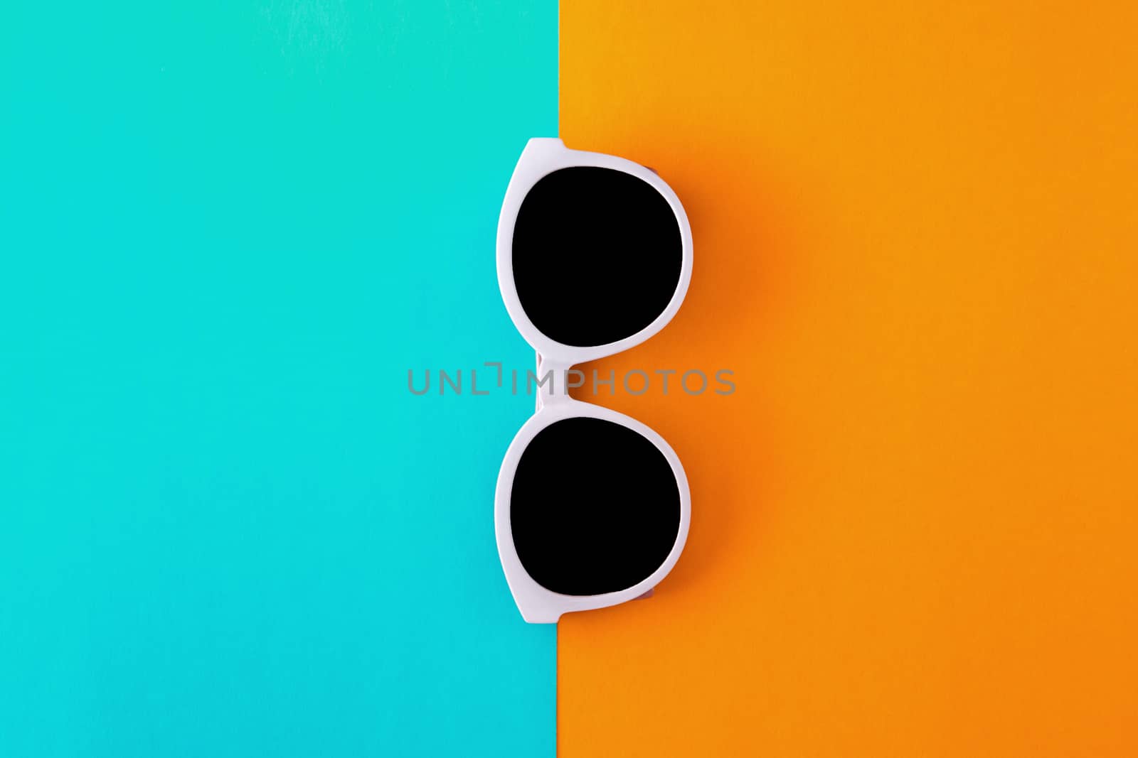 Sunny stylish white sunglasses on a bright blue-cyan and yellow- by Tanacha