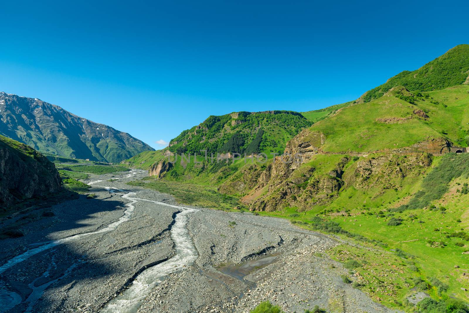 Blue sky over the high scenic Caucasus Mountains in Georgia on t by kosmsos111