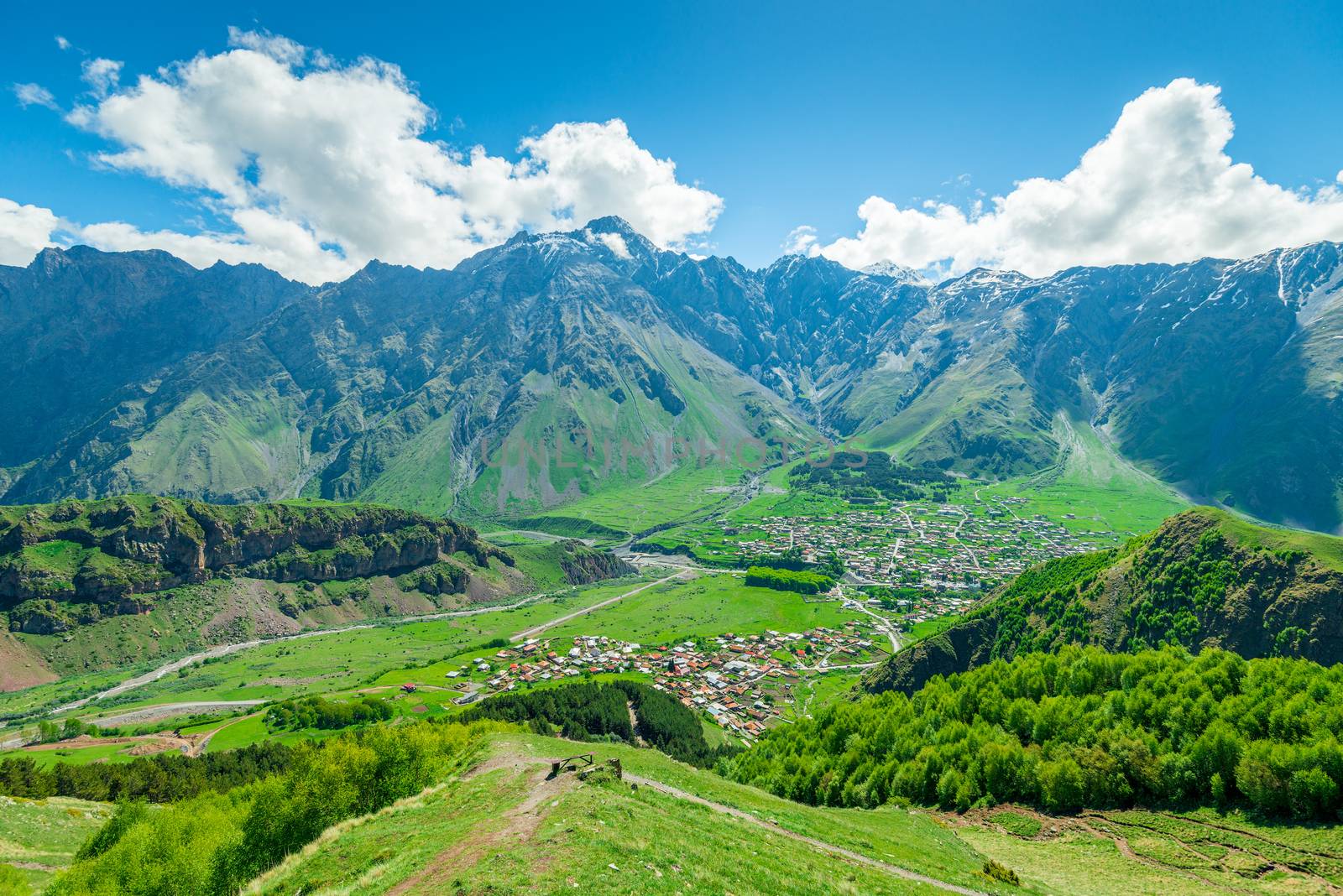 The village of Gergeti in the valley of the Caucasus in Georgia against the backdrop of high beautiful mountains