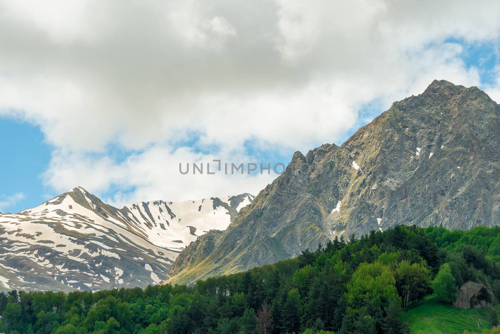 High mountains with remnants of snow on top in Georgia in summer, Caucasus