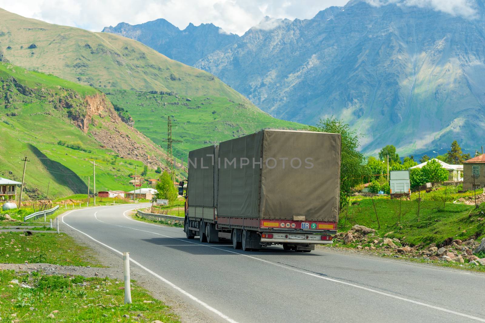 Trailer with cargo on the road in the mountains of the Caucasus