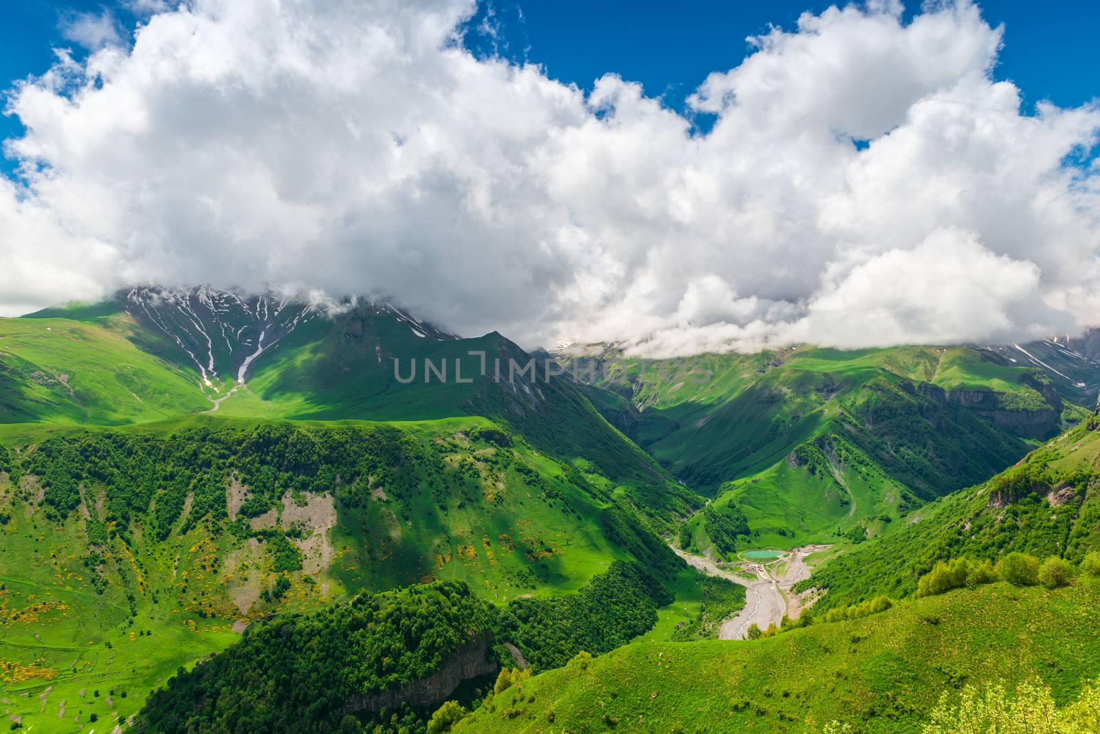 Beautiful cumulus clouds over the gorge and high mountains of th by kosmsos111