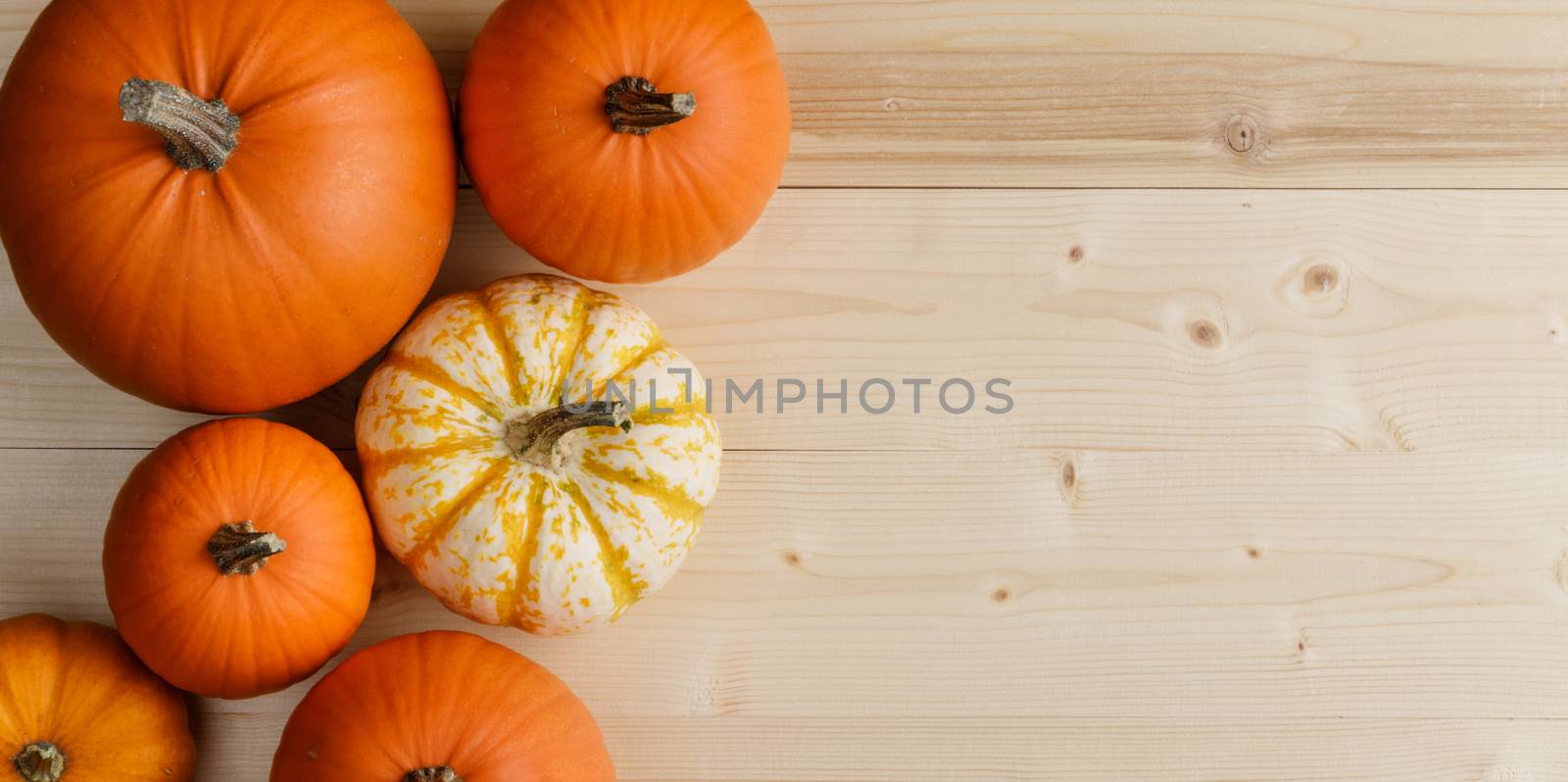 Many orange pumpkins on wooden background , Halloween concept , top view with copy space