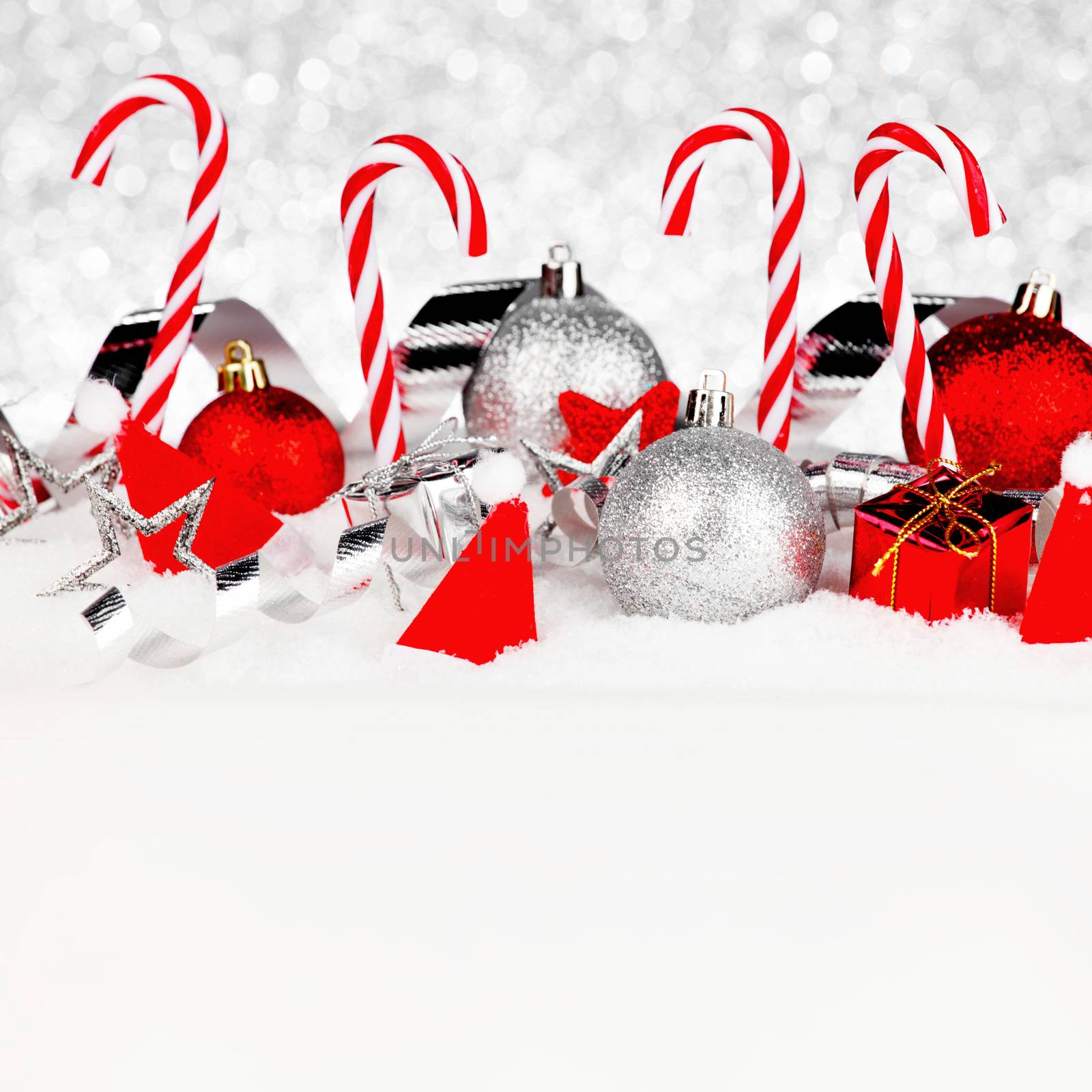 Christmas card with beautiful decorations and candies in snow