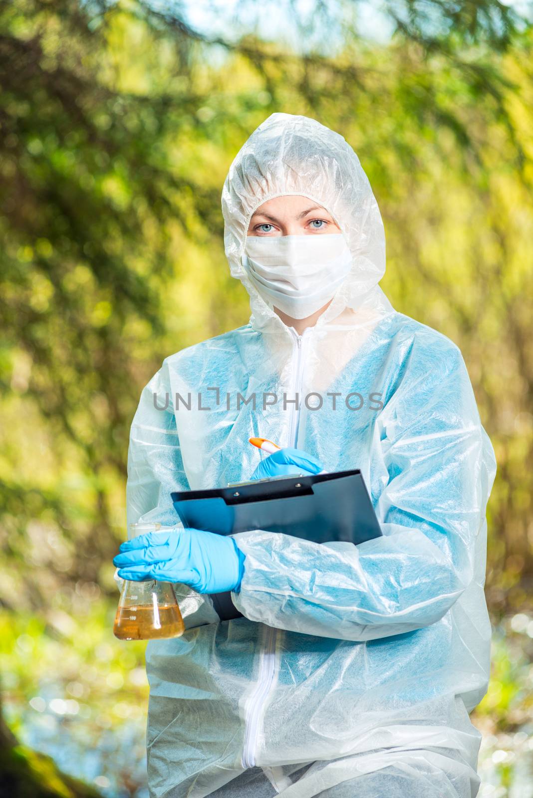 ecologist examines the water from the river and records the resu by kosmsos111