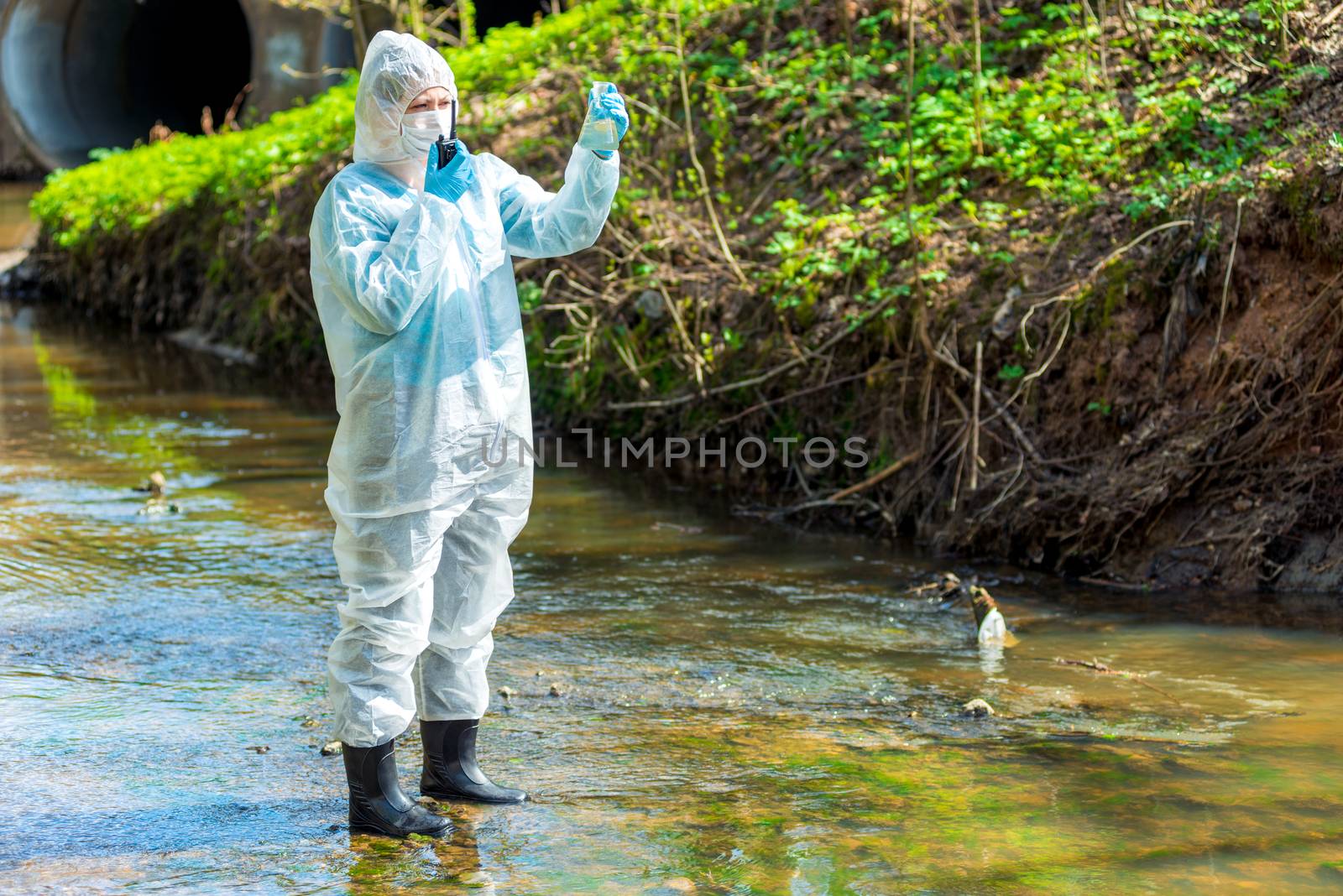 a scientist with a sample of contaminated contaminated water wit by kosmsos111