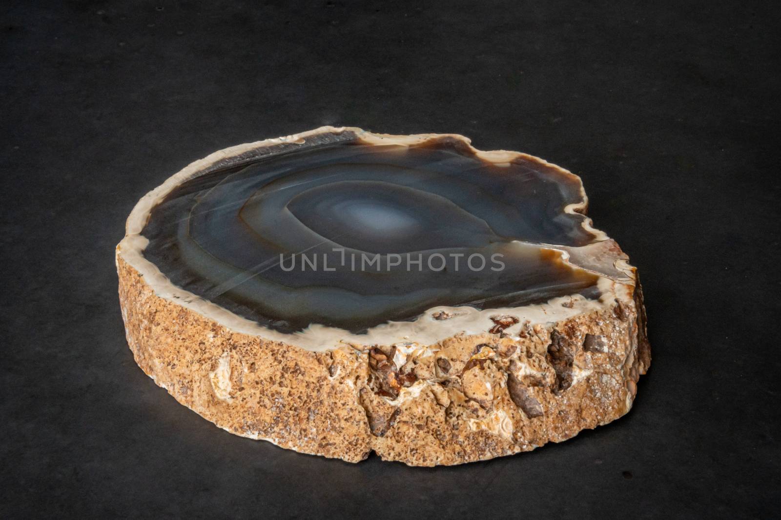 Slice of Geode blue colorful gemstone looking like normal rock from outside not hollow inside