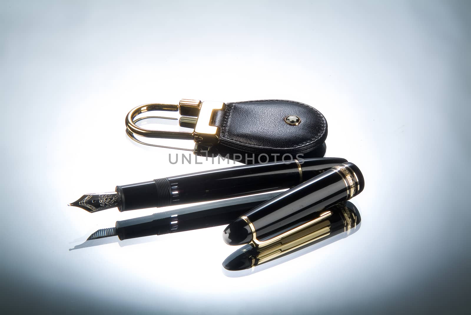 Keychain and pen on a glass studio background