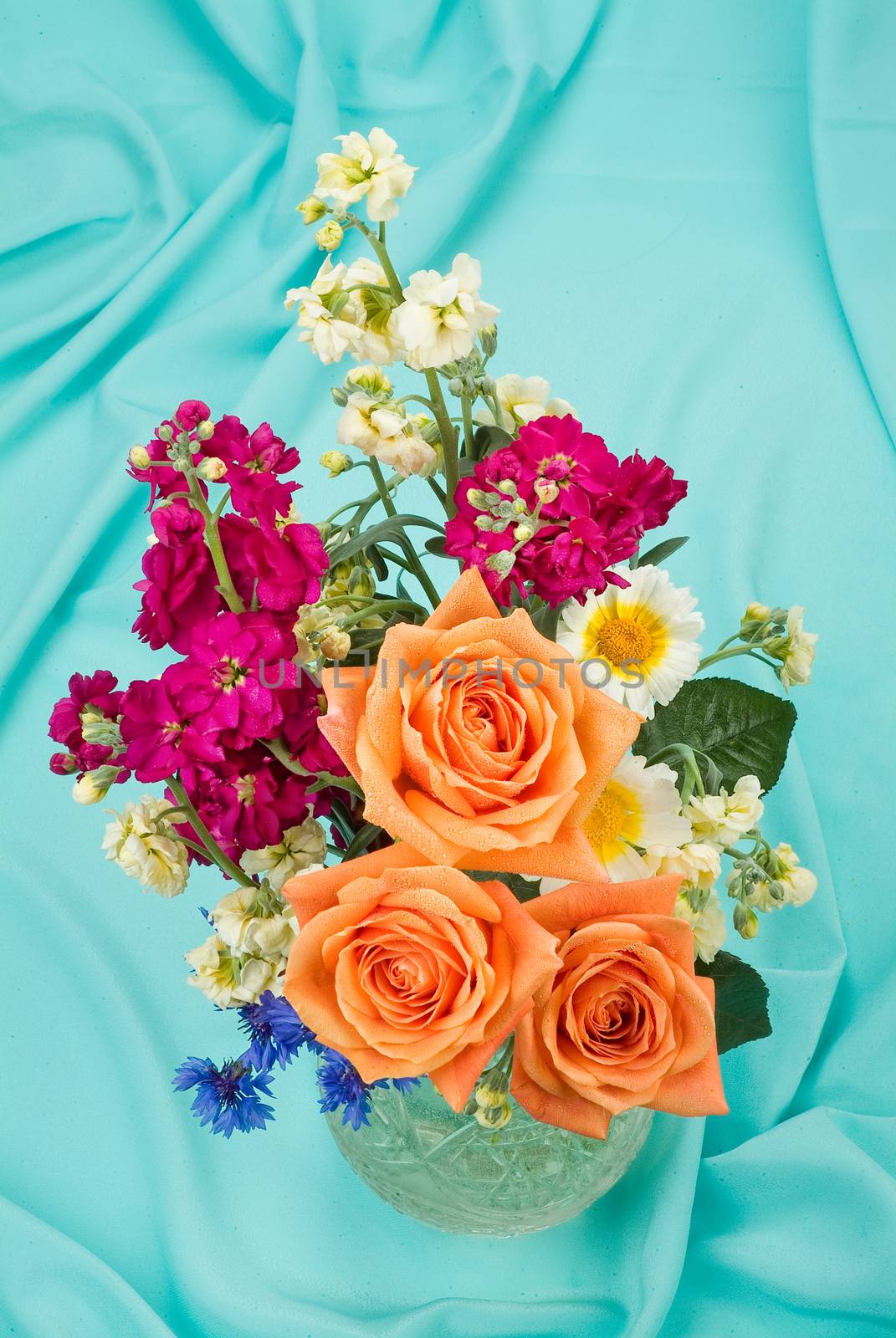 Still life with bouquet of flowers and accessories on a studio background