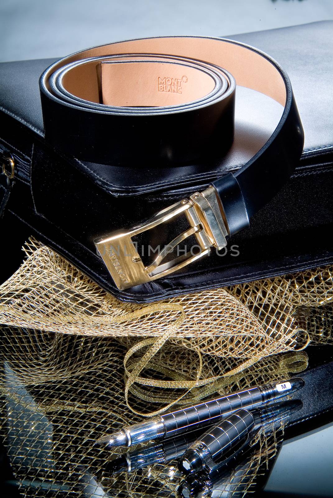 Leather belt and pen on a glass background