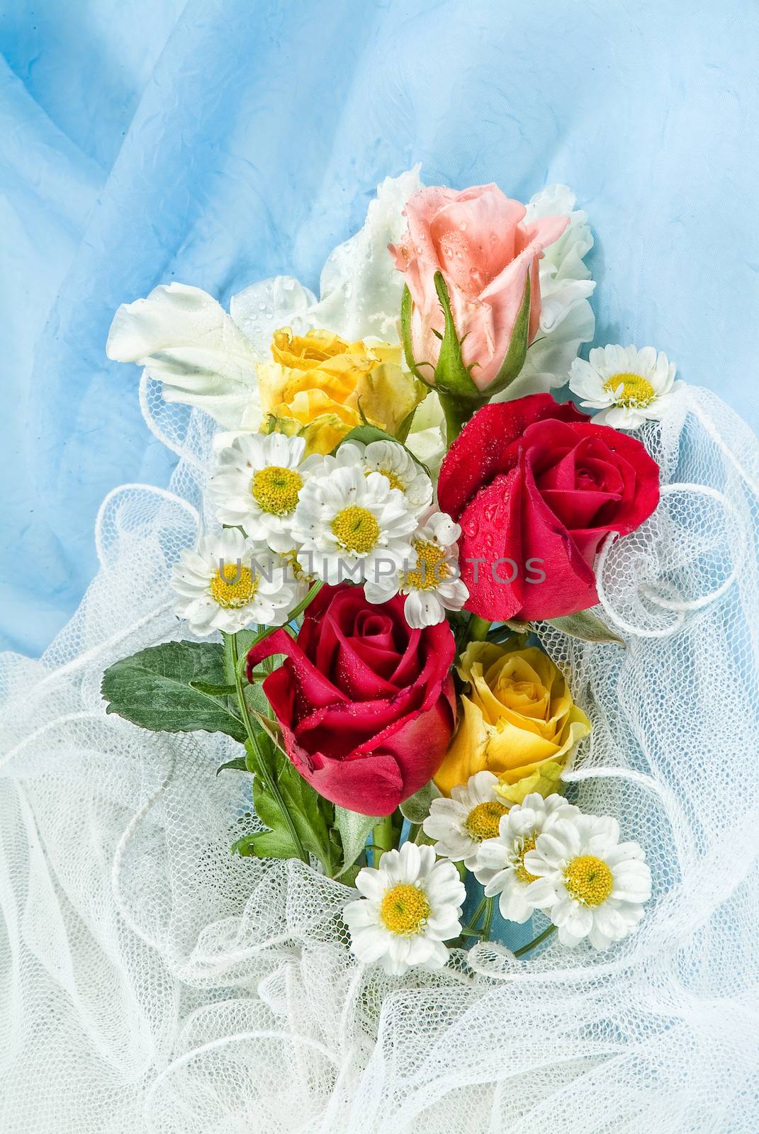 Still life with bouquet of flowers and accessories on a studio background